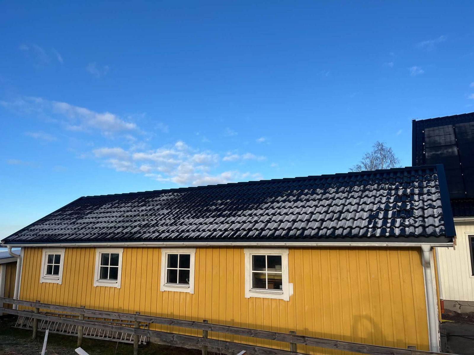 Gult hus i Otterbäcken med nytt svart tak